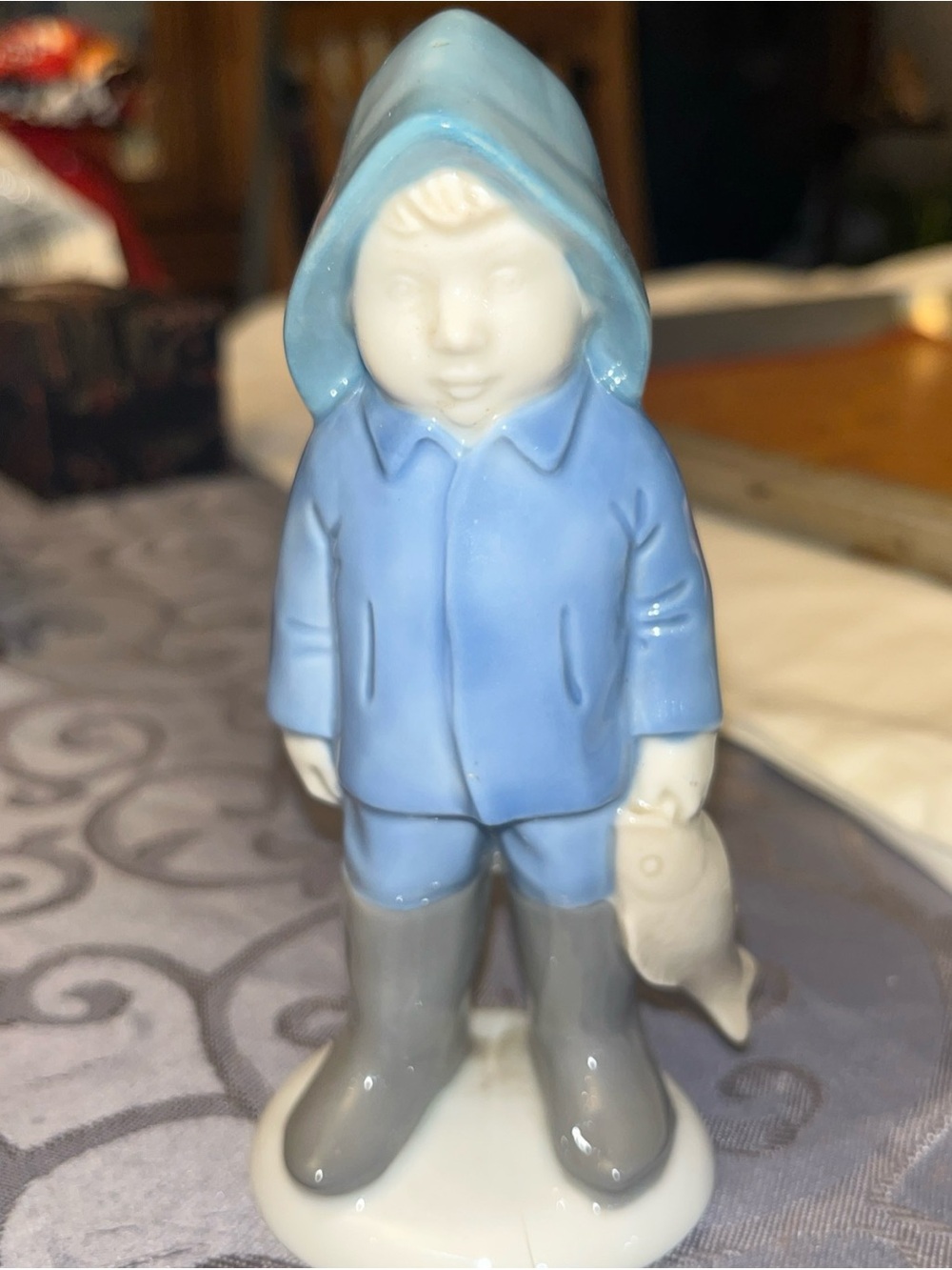 Porcelain Boy Figurine in Light Blue Raincoat and Gray Boots